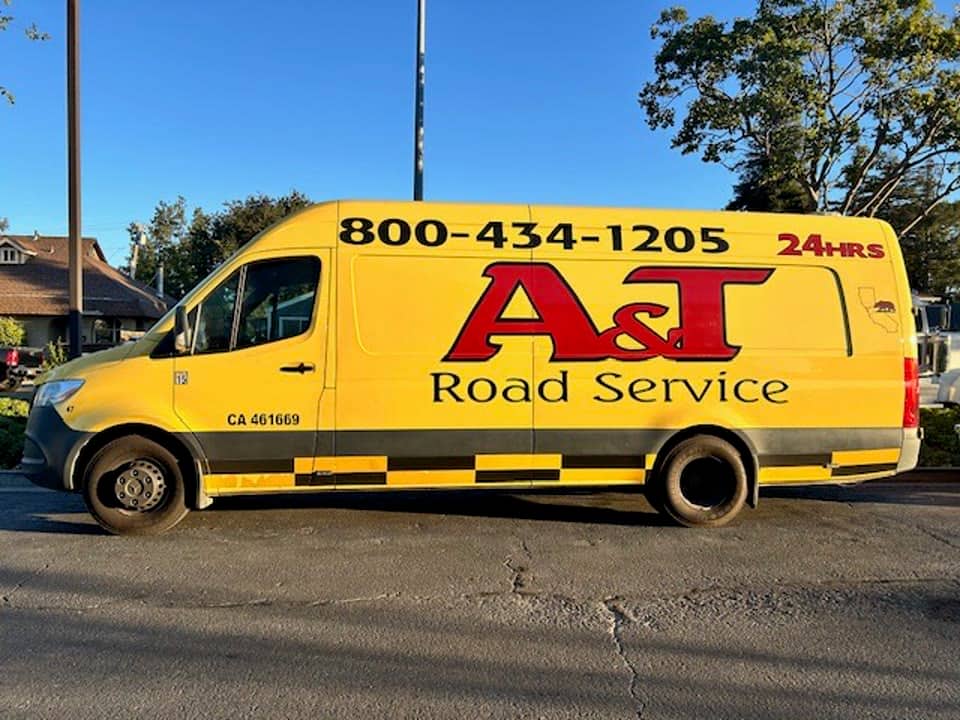 A&T Road Service yellow Sprinter van with 800-434-1205 branding