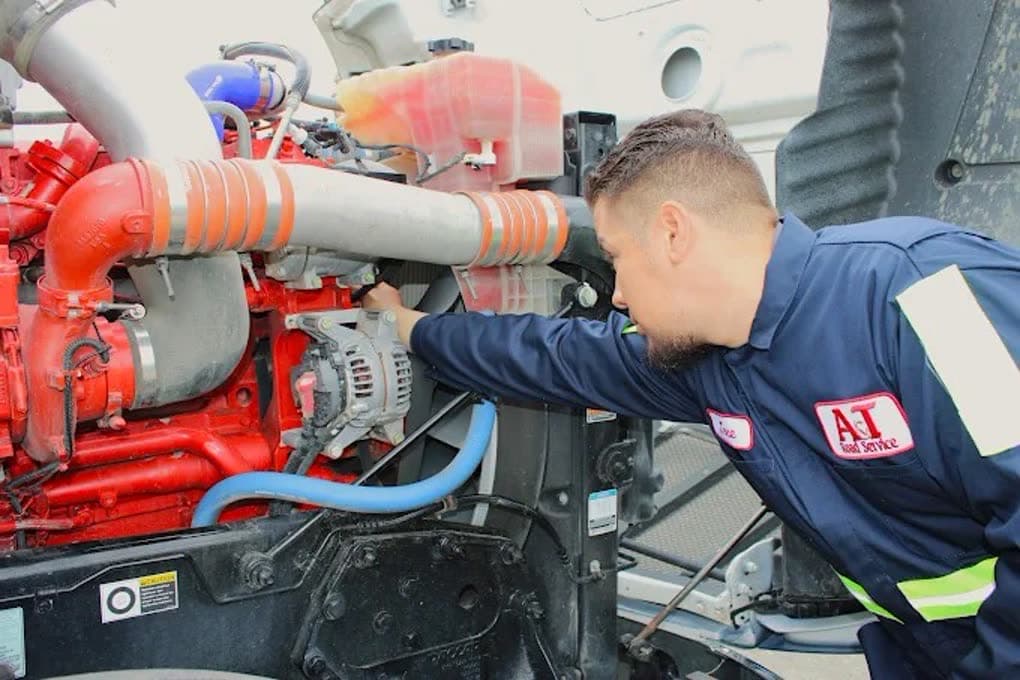 Class 8 diesel engine bay open for on-site mobile diesel and trailer repair