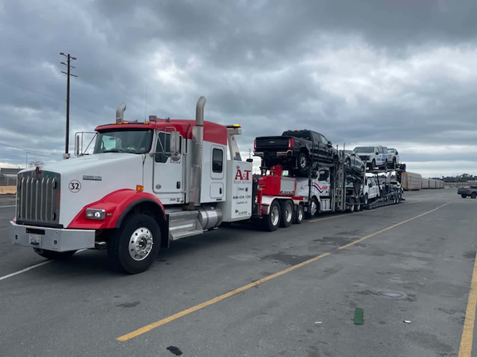 A&T Kenworth #32 Big Red towing a loaded car carrier on a recovery job
