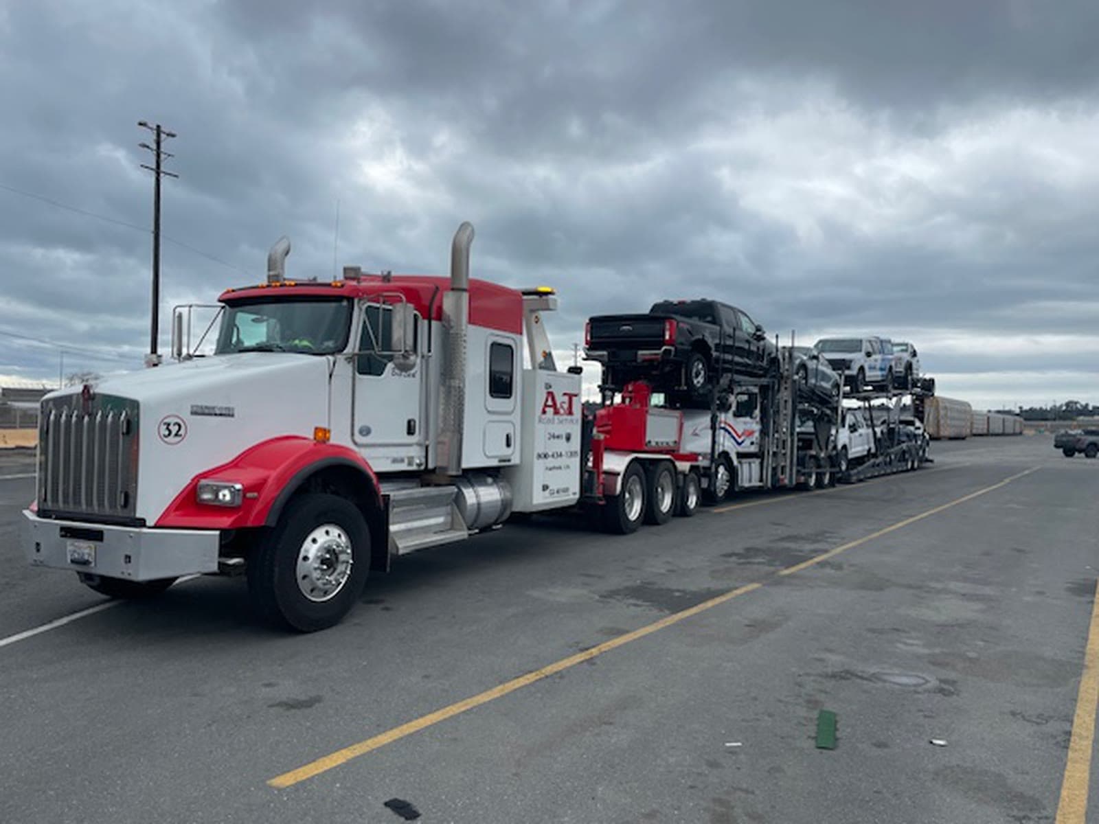 A&T Kenworth #32 Big Red towing a loaded car carrier on a recovery job